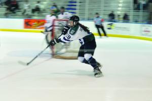 Tyler Stauffer photo: Freshman Stephanie DeSutter clears the puck from the Lakers defensive zone.